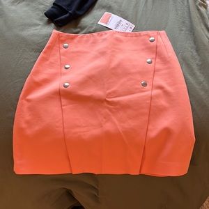 ORANGE SKIRT WITH BUTTONS